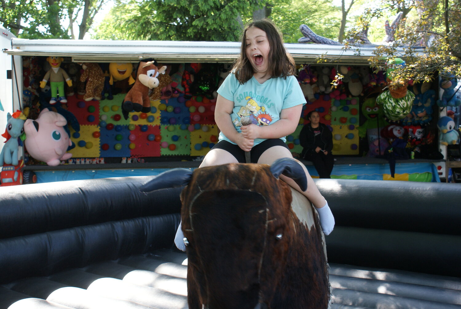 NO BULL HERE: Nine-year-old Skylah Lemoi screams with joy as she holds desperately on for her first mechanical bull ride. (Photo by Steve Popiel)